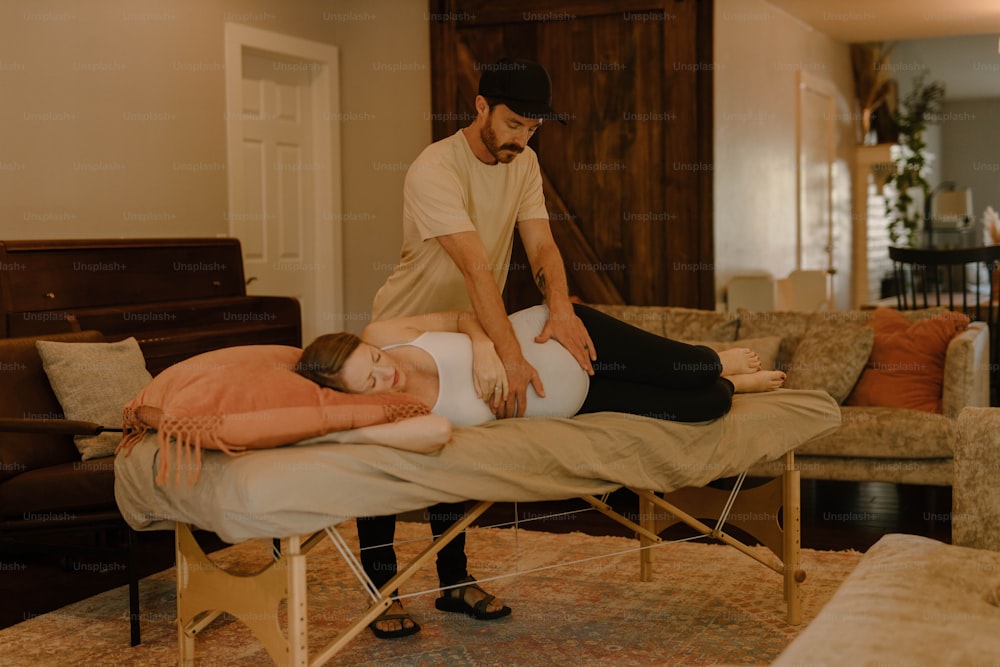 a man standing over a woman laying on a bed