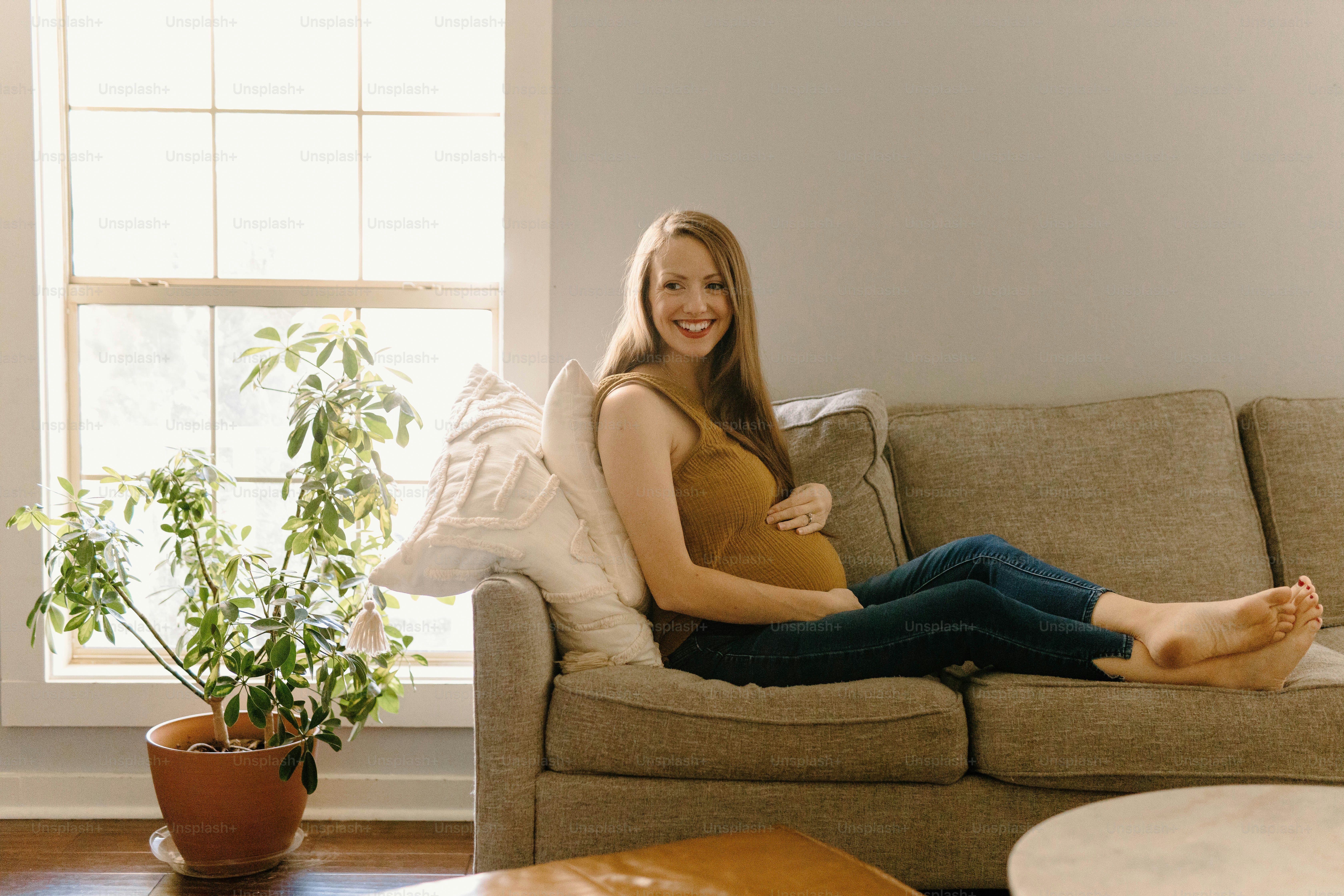 a woman sitting on a couch with her legs crossed