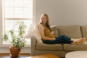 a woman sitting on a couch with her legs crossed