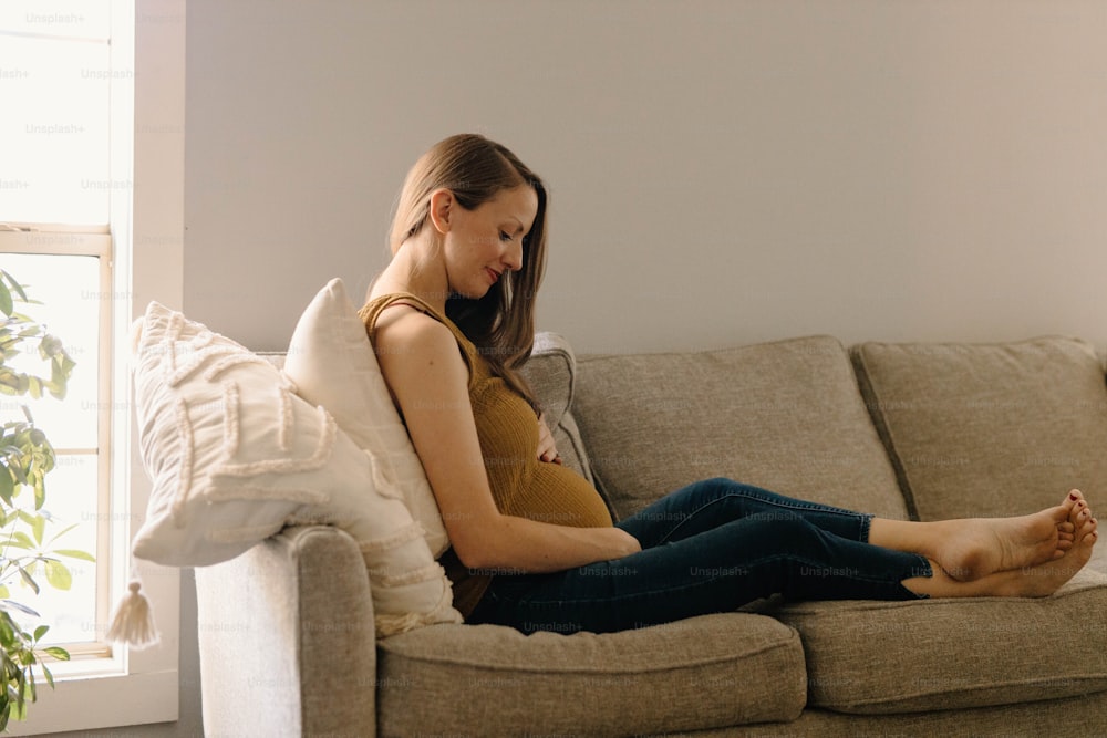 a woman sitting on a couch with her legs crossed