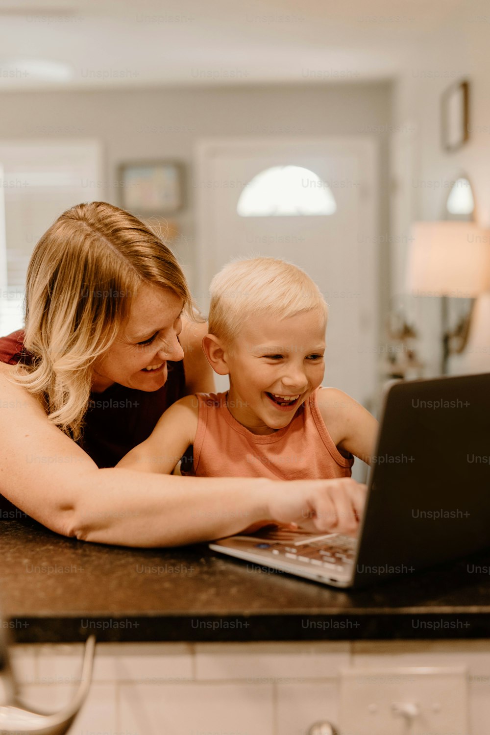 Uma mulher e uma criança estão olhando para um laptop