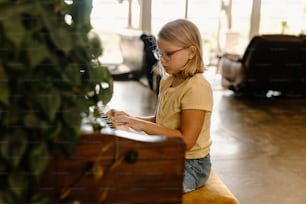 a young girl playing a piano in a room