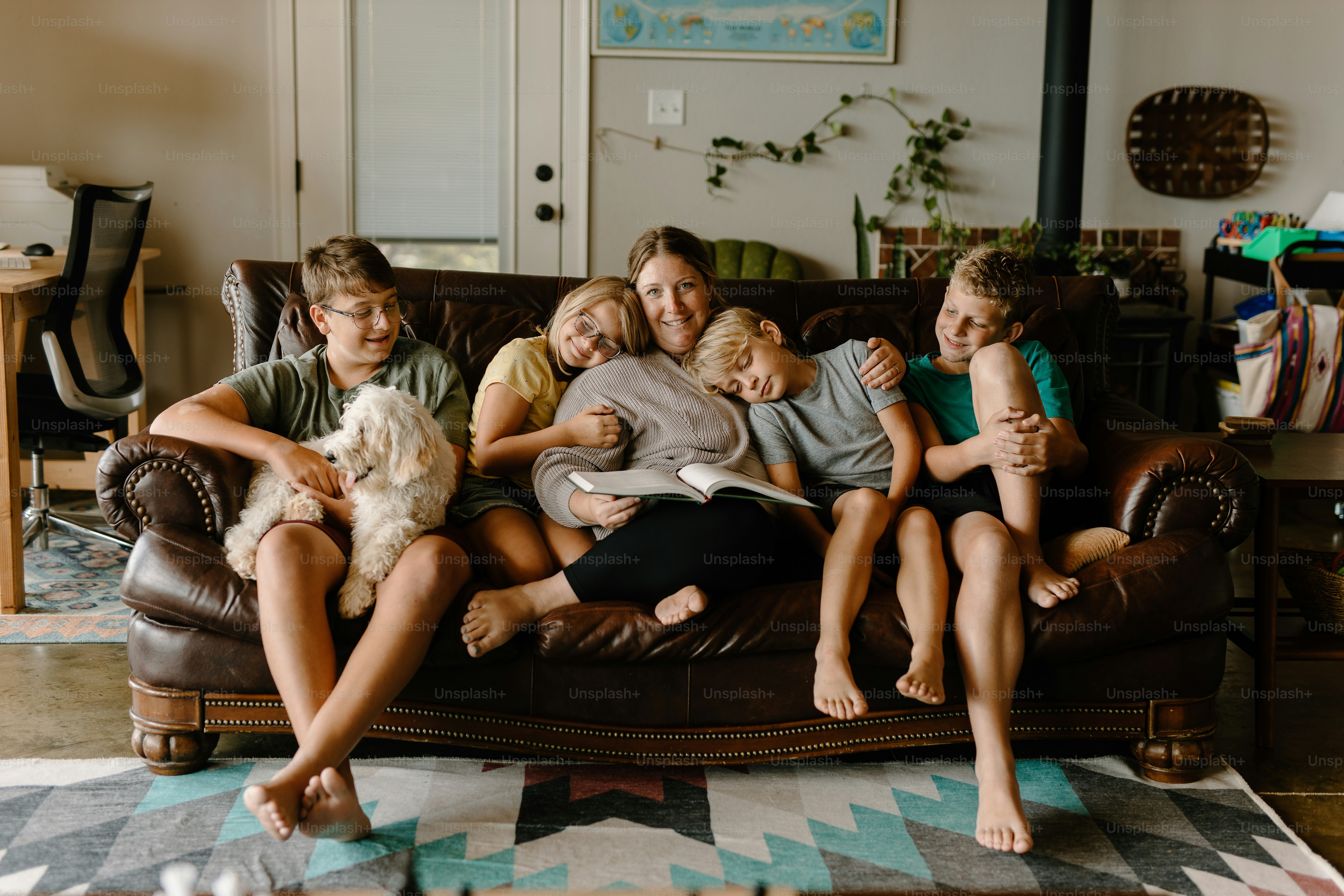 a group of people sitting on a couch with a dog