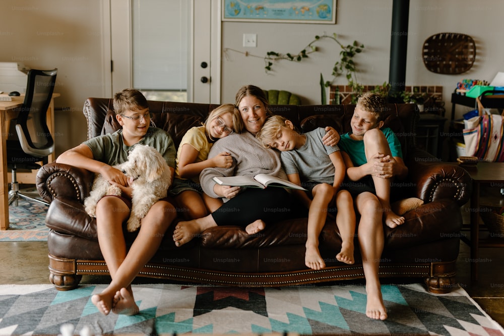 a group of people sitting on a couch with a dog