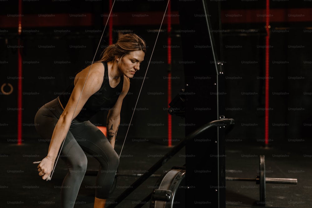 a woman squatting on a bar in a crossfit gym