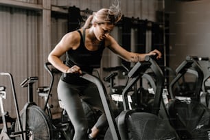 a woman on a stationary bike in a gym