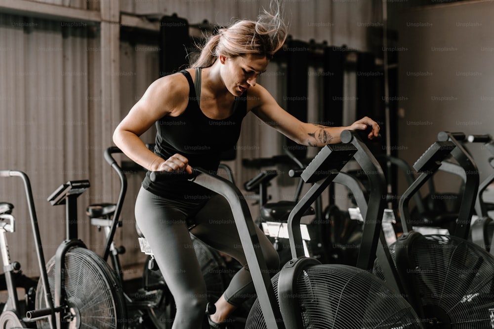 a woman on a stationary bike in a gym