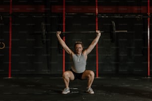 a woman squatting with a barbell on her back