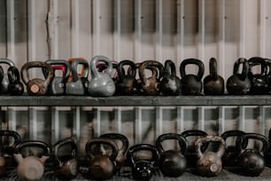 a row of kettles sitting on top of a metal shelf