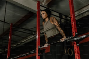 a woman holding a bar in a gym