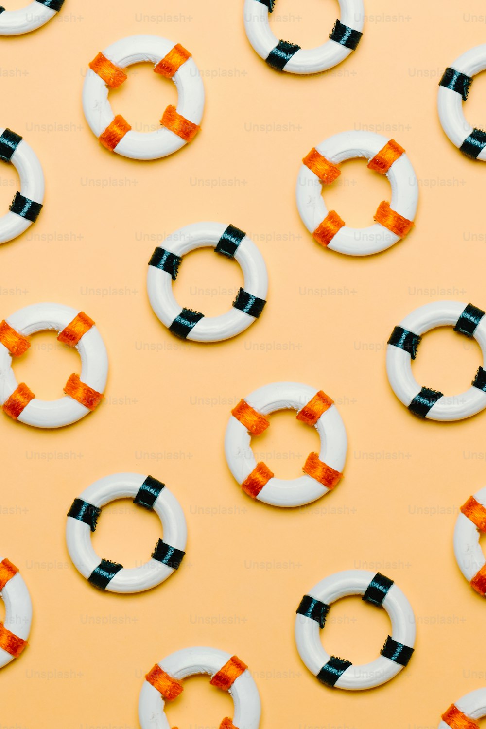 a group of white and black rings on a yellow background