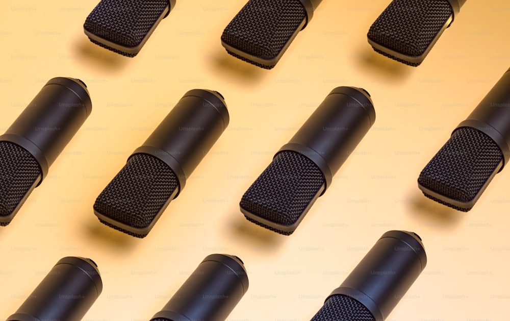 a group of black microphones sitting on top of a table