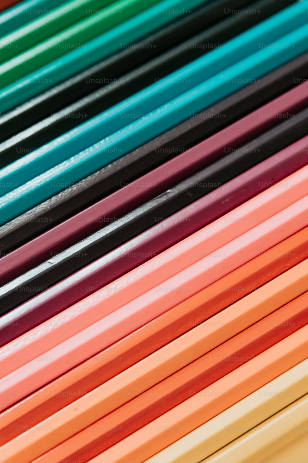 a stack of colored pencils sitting on top of each other