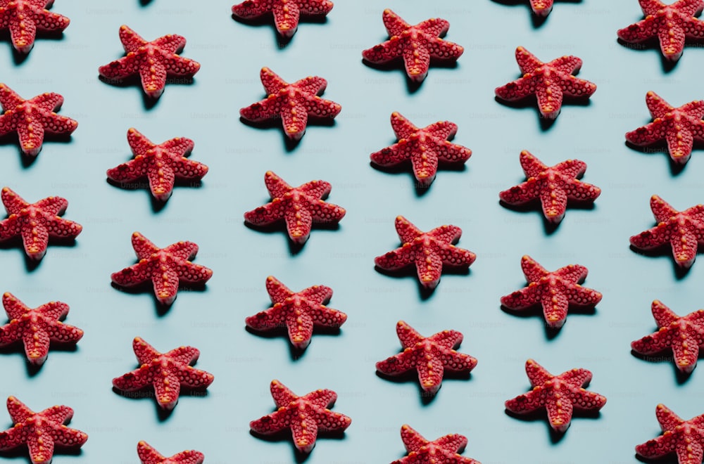 a group of red candies on a blue surface