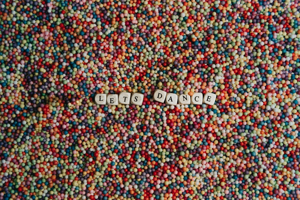 a close up of a pile of beads with the word do not enter spelled in