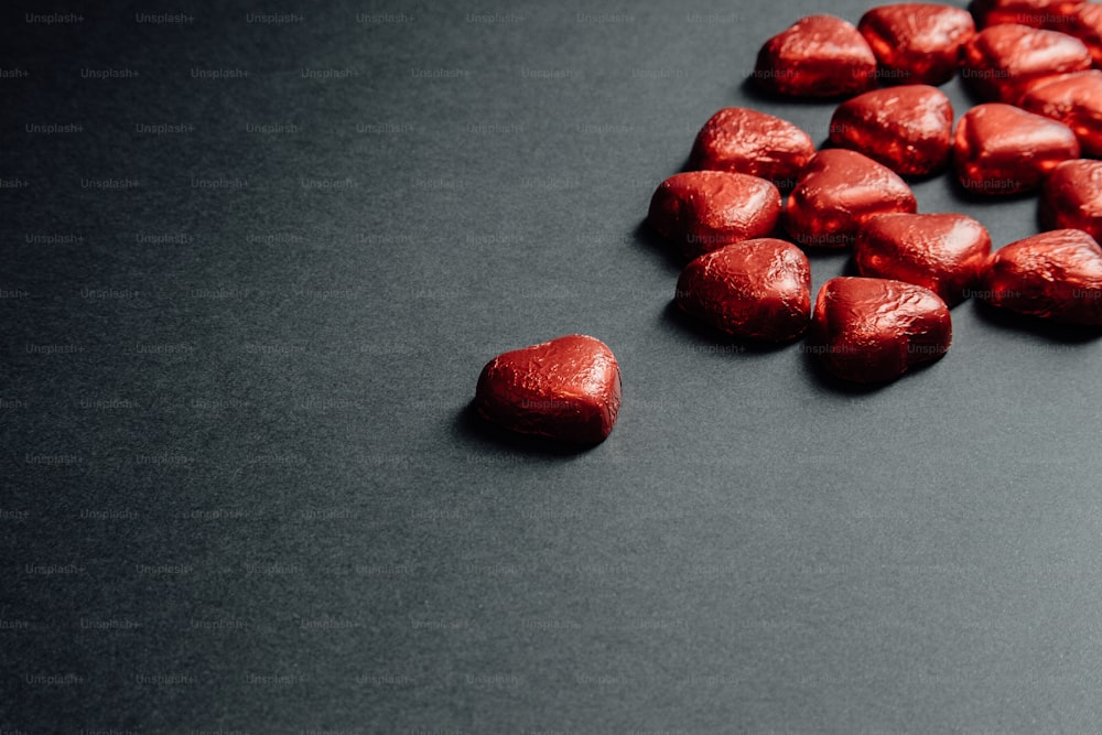 a pile of heart shaped candy on a table