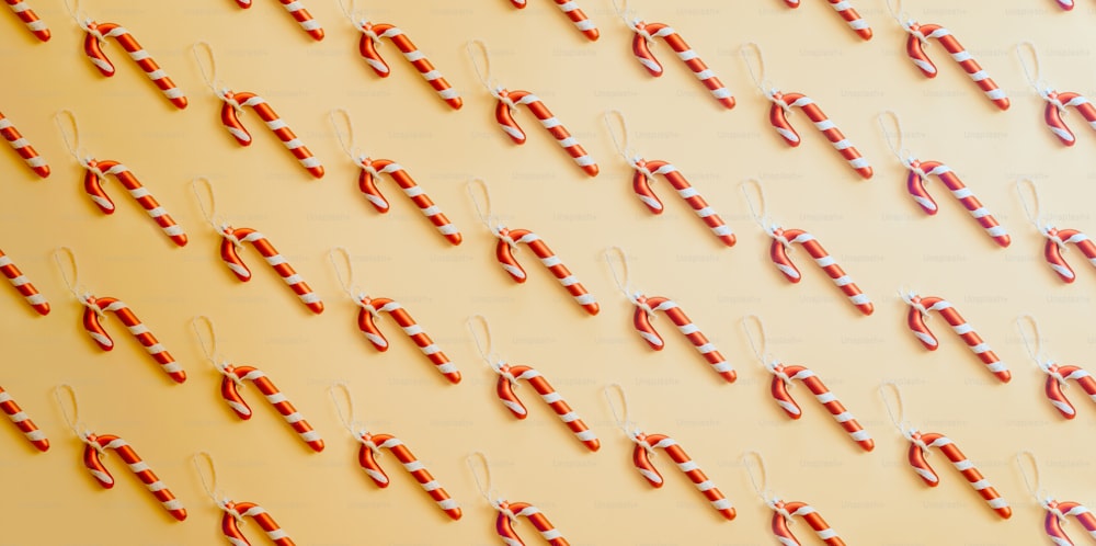 candy canes are arranged on a yellow background