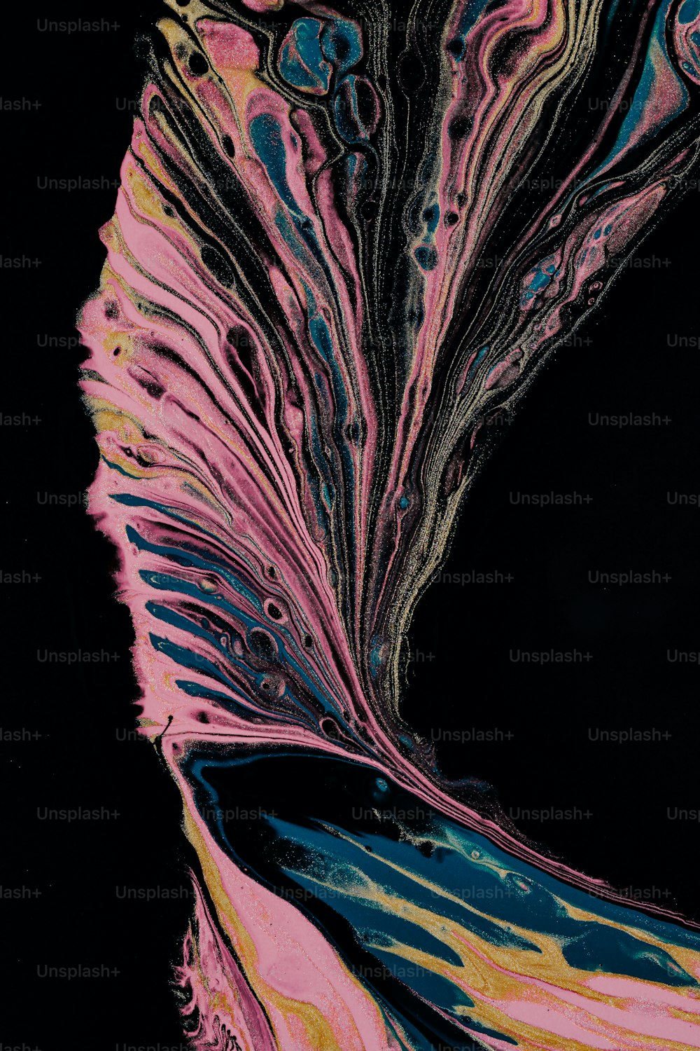 a black background with a pink and blue swirl