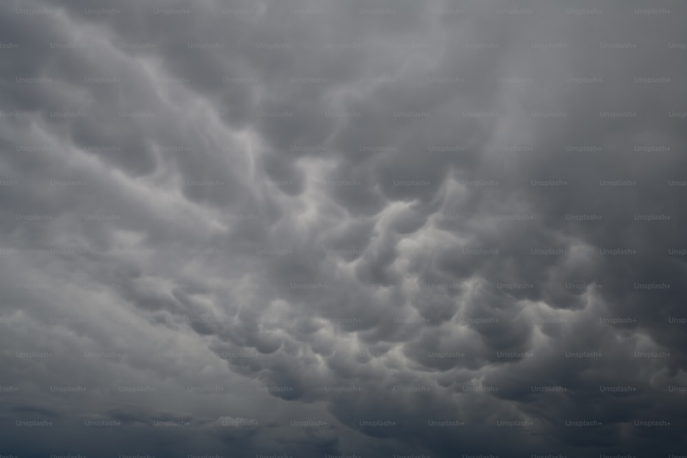 a plane is flying in the cloudy sky