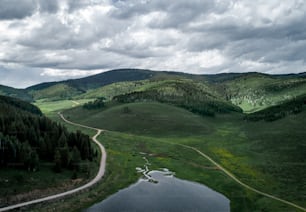 an aerial view of a winding road in the mountains