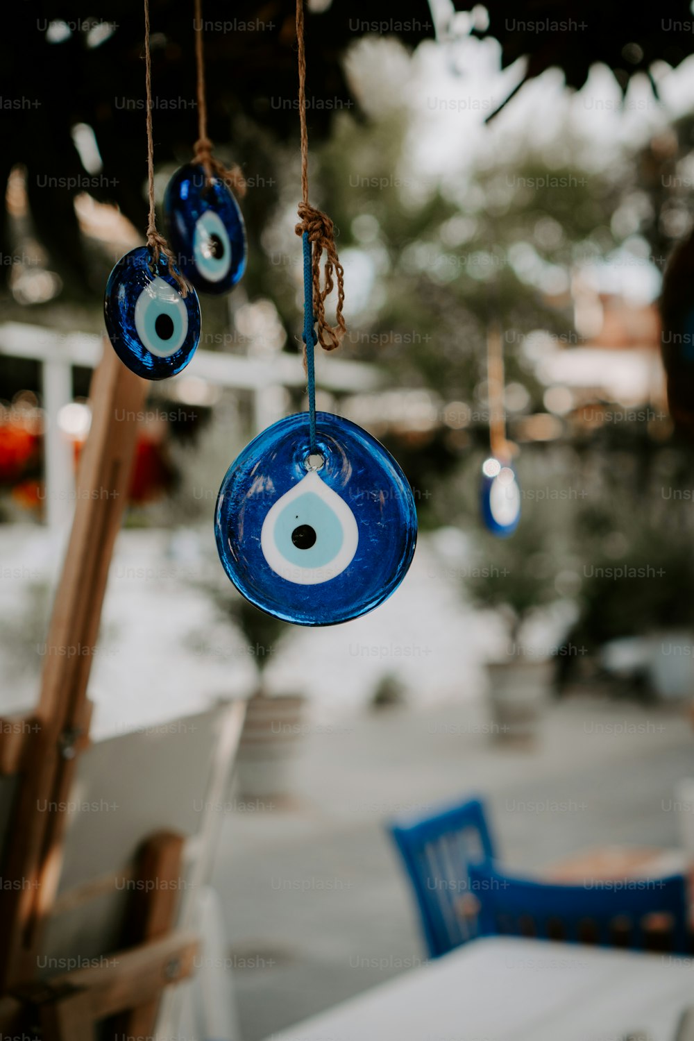 a blue glass eyeball hanging from a rope