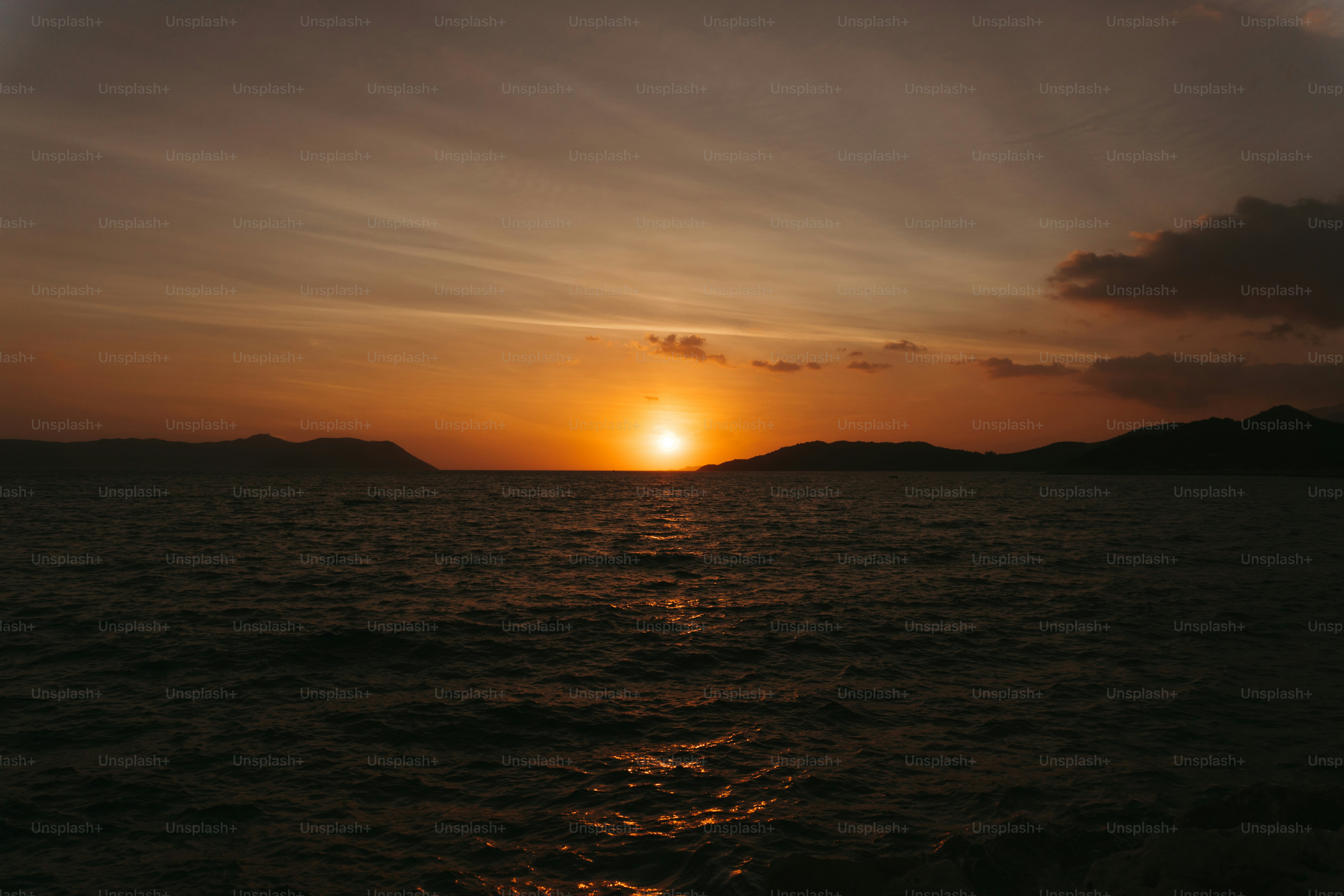 the sun is setting over a body of water