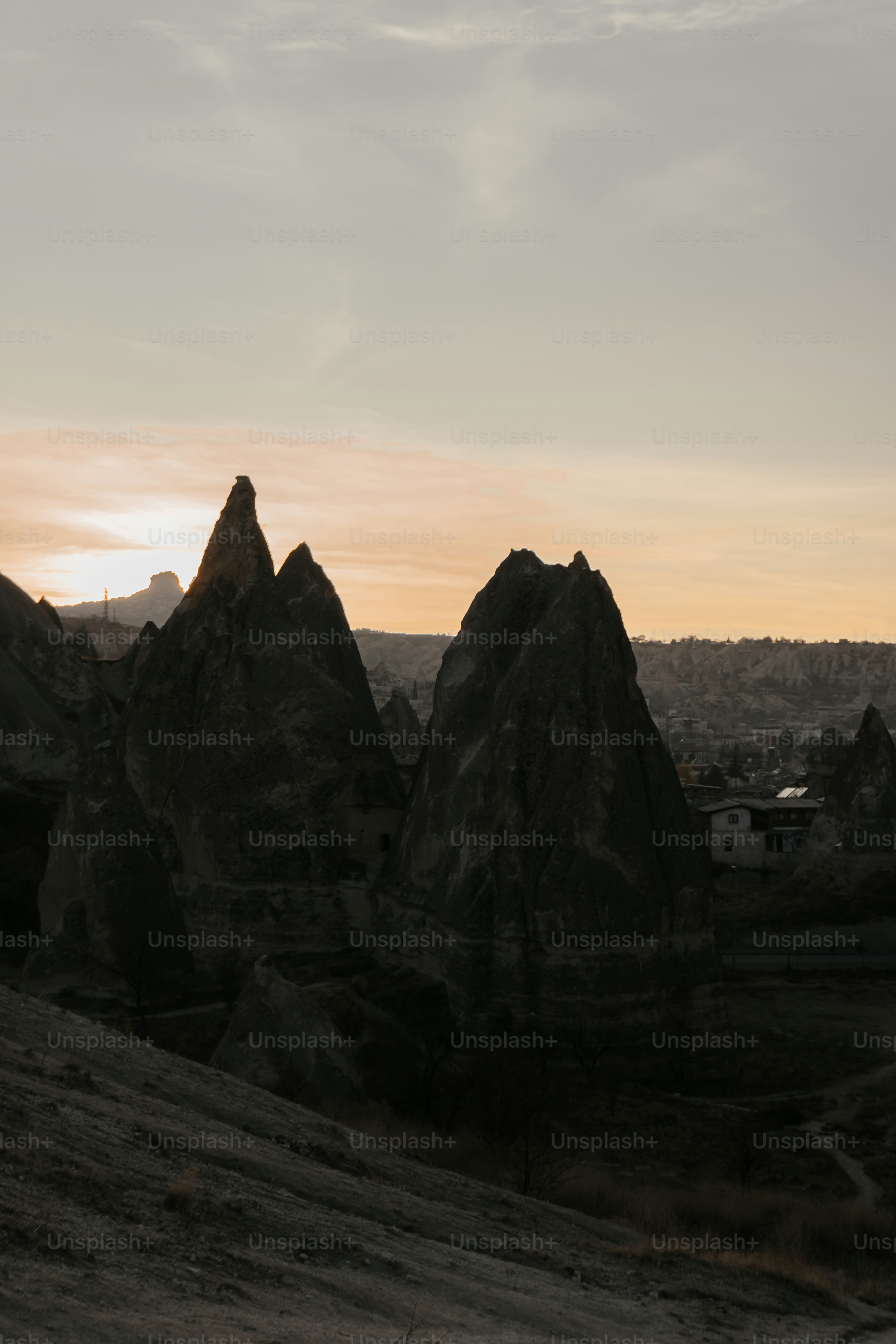 the sun is setting over the rocky terrain
