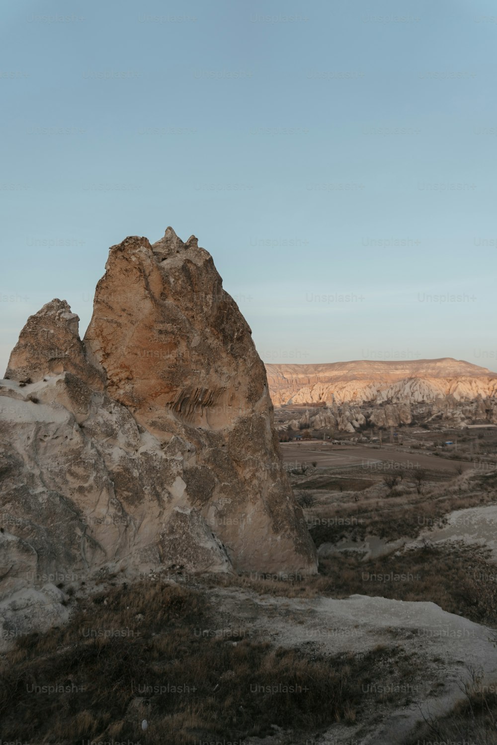 a large rock formation in the middle of a desert