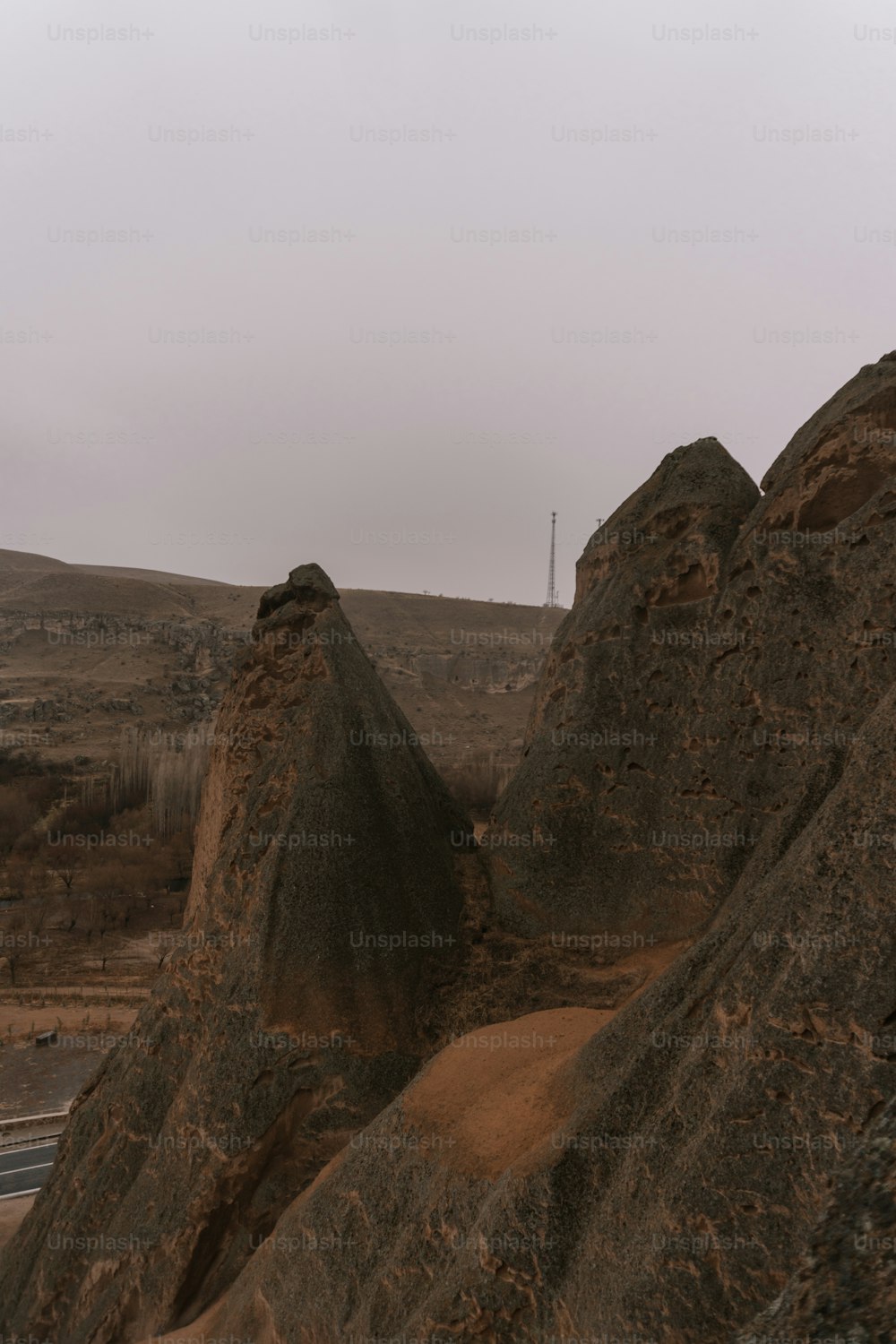 a couple of large rocks sitting on the side of a road