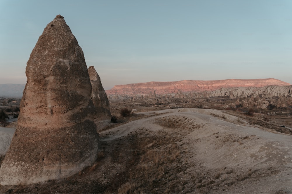 a large rock formation in the middle of a desert