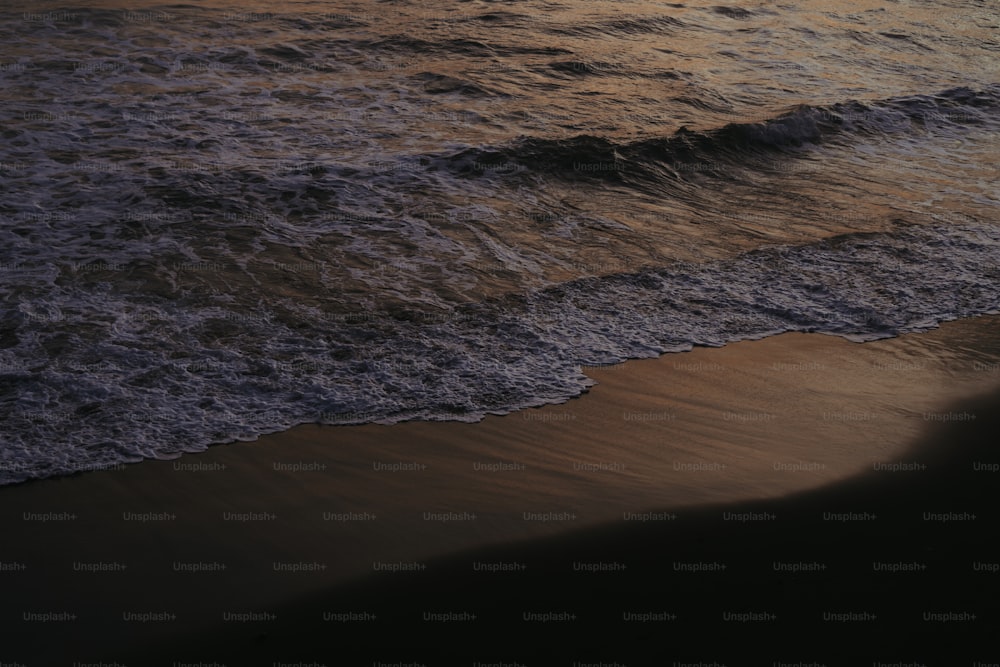 a beach with waves coming in to shore