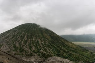 a very tall mountain covered in lots of clouds