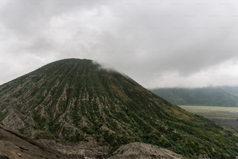 a very tall mountain covered in lots of clouds