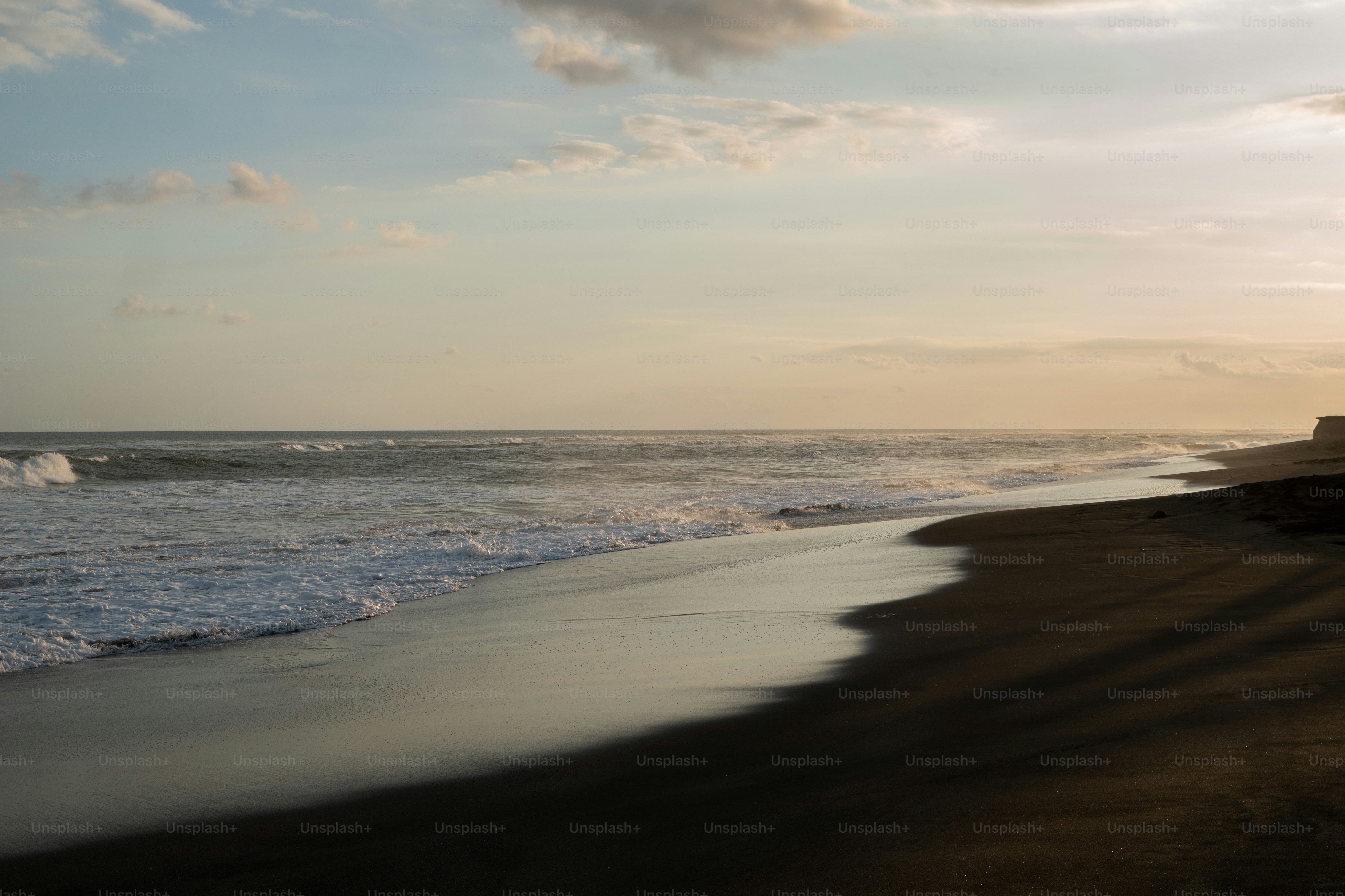 a beach with waves coming in to shore