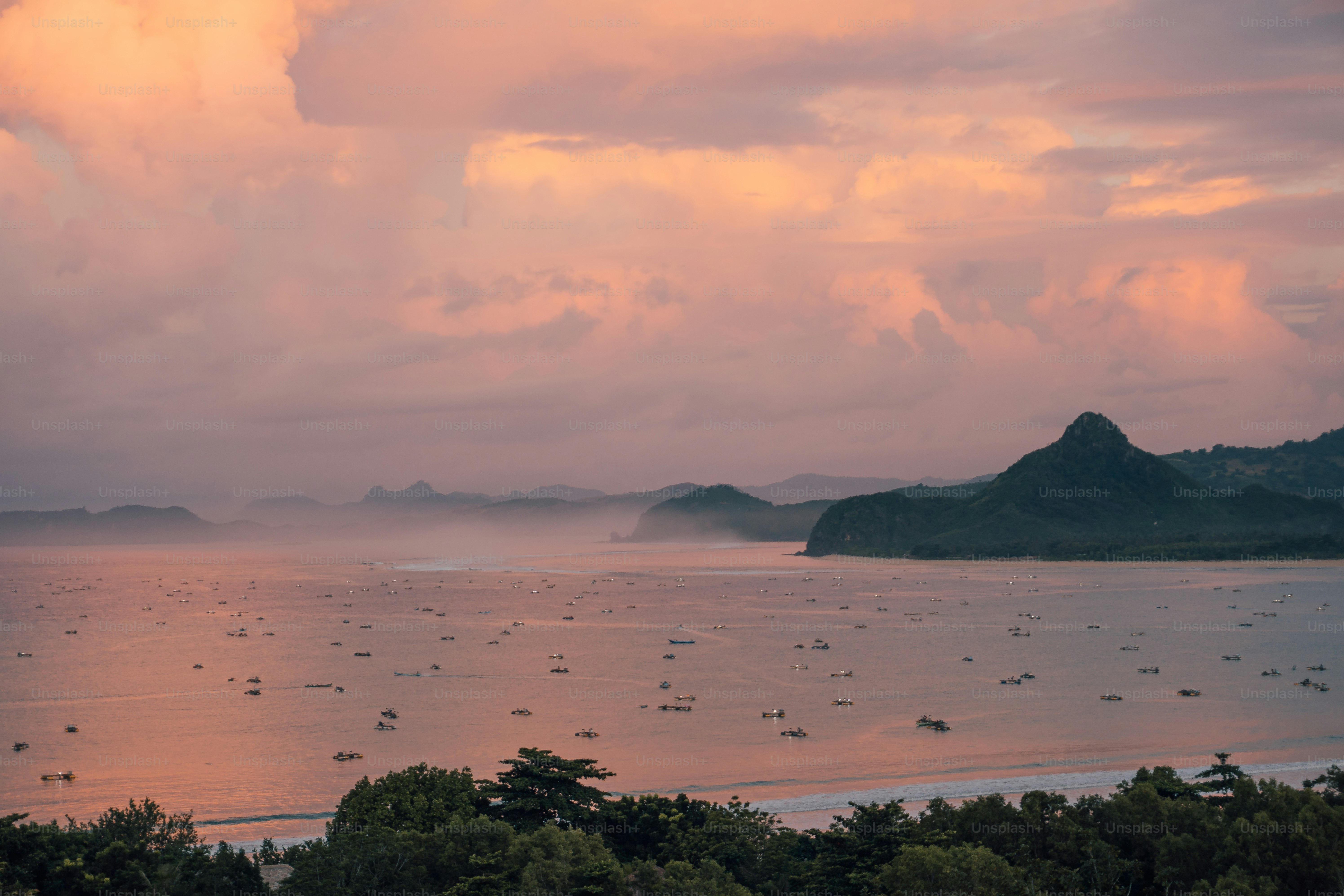 a group of boats floating on top of a large body of water