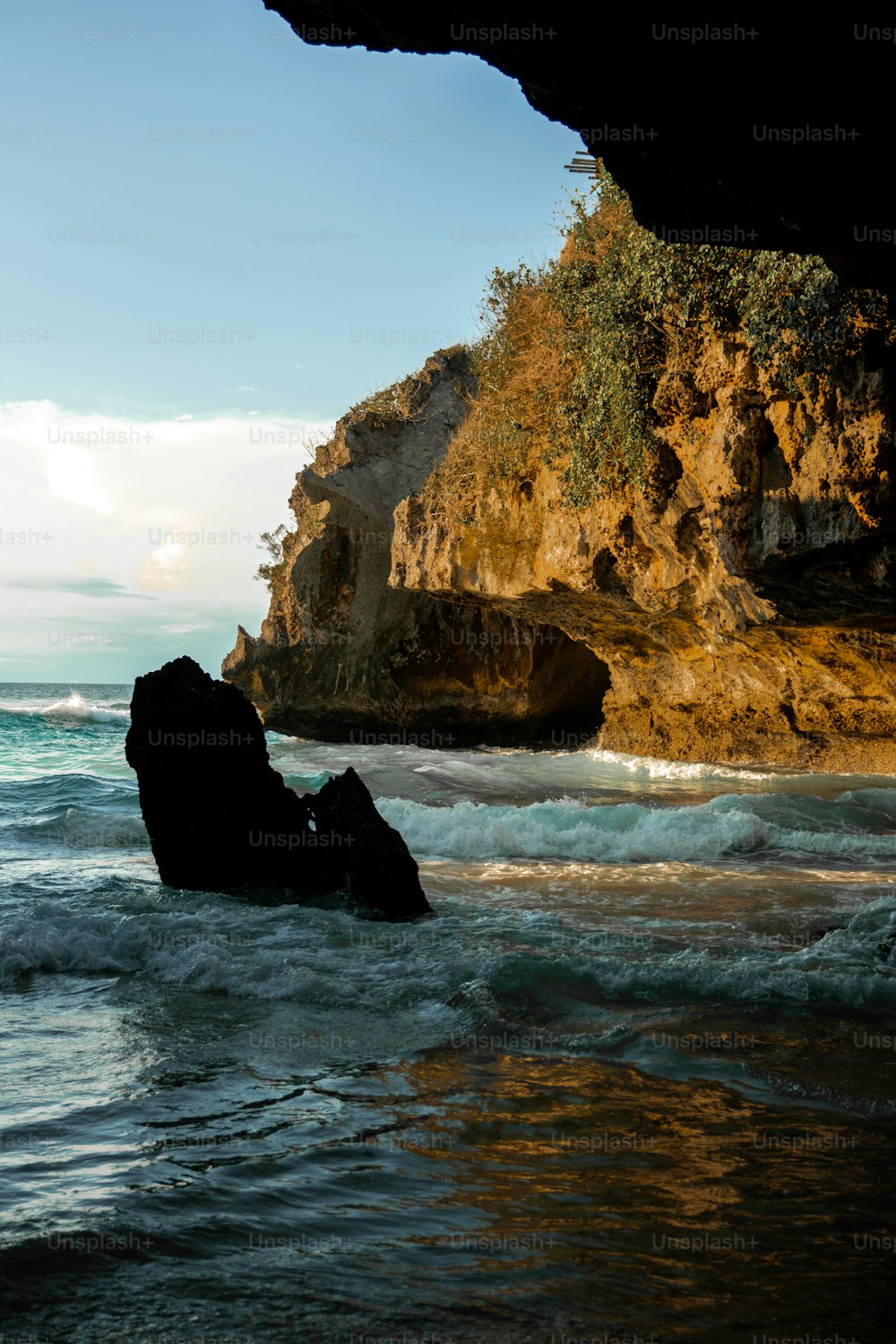 a large rock sitting in the middle of a body of water