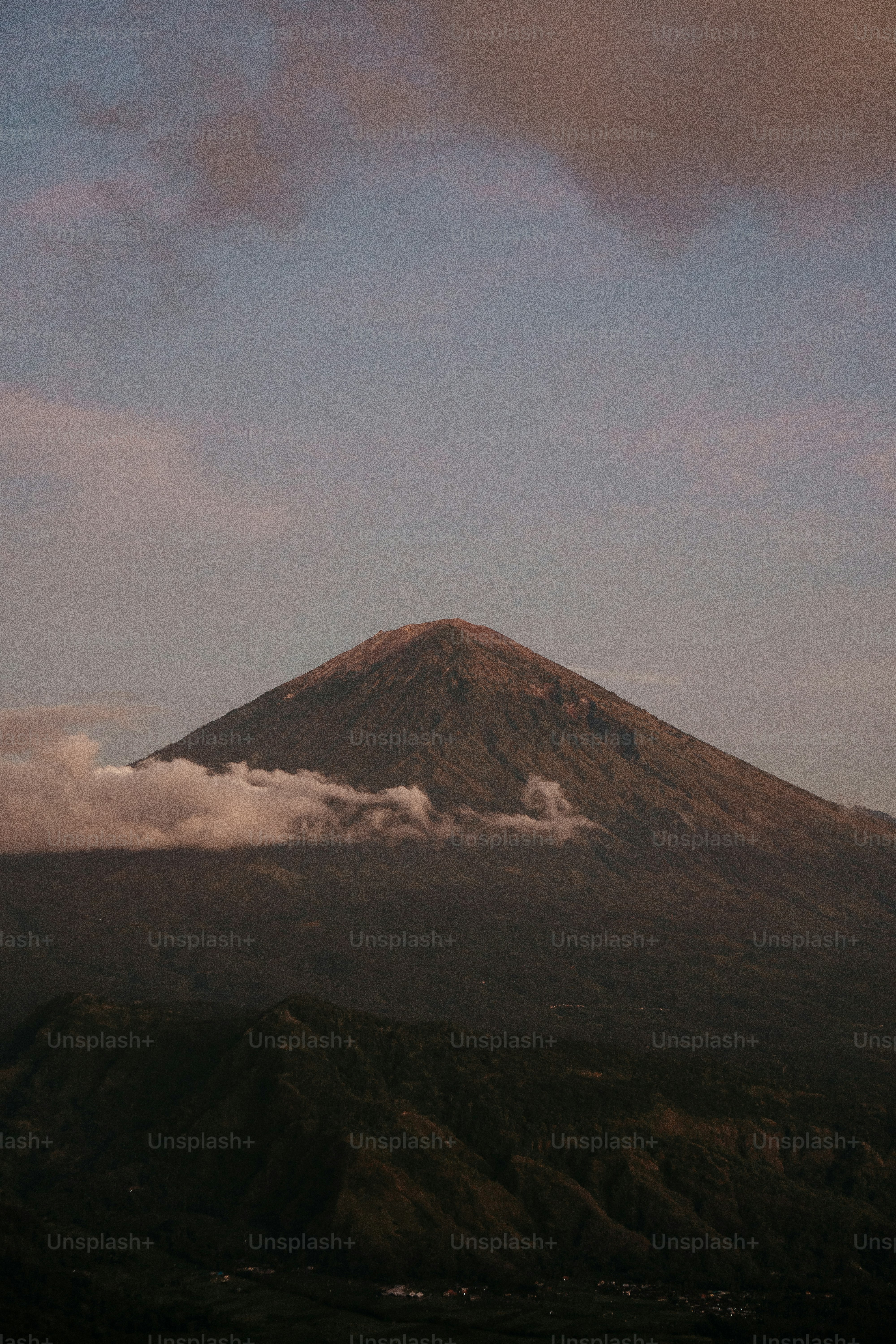 a mountain covered in clouds on a cloudy day