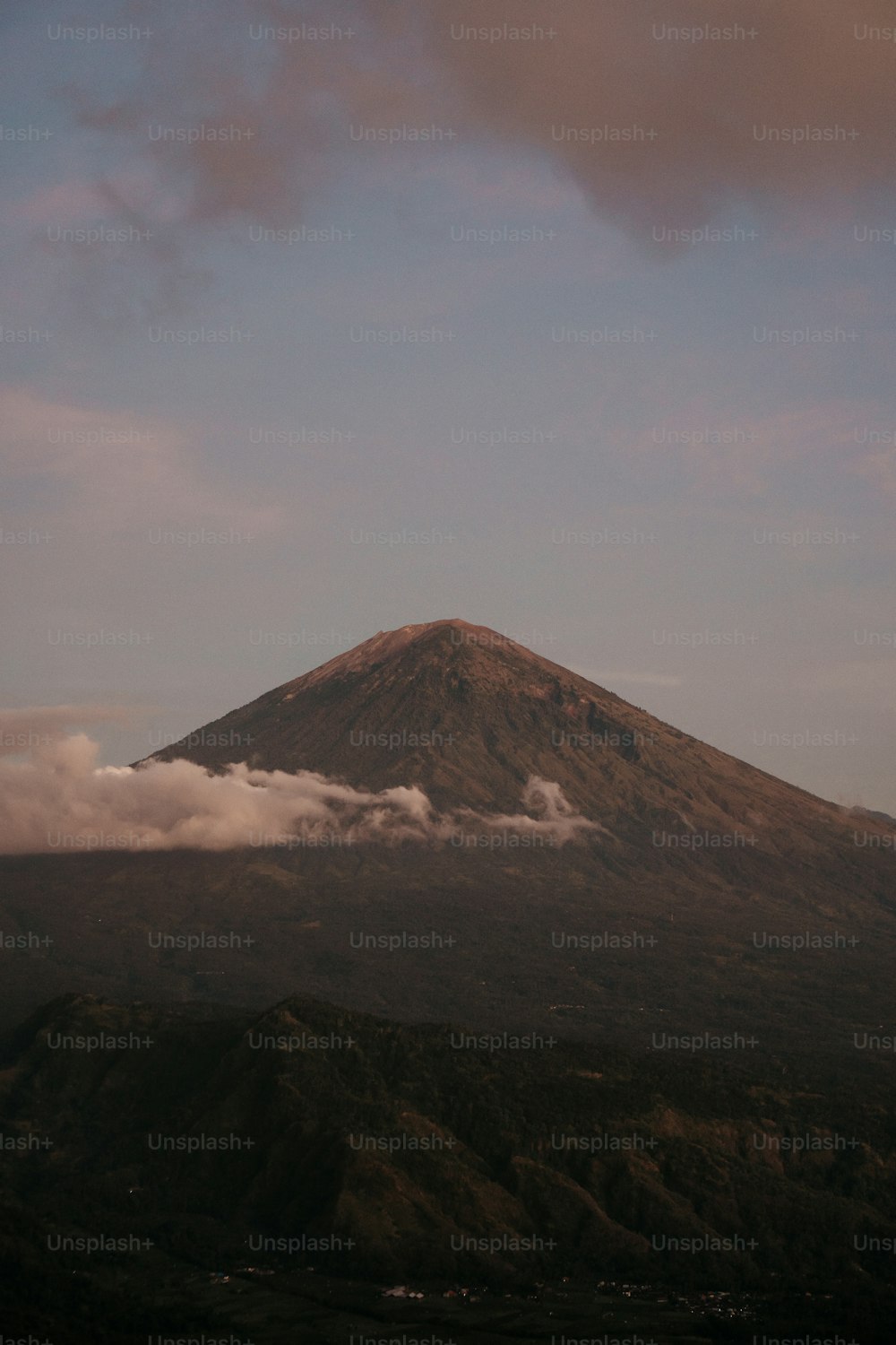 a mountain covered in clouds on a cloudy day