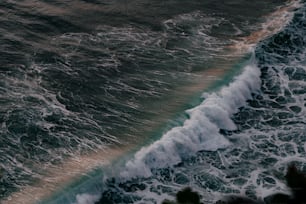 a person riding a surfboard on top of a wave