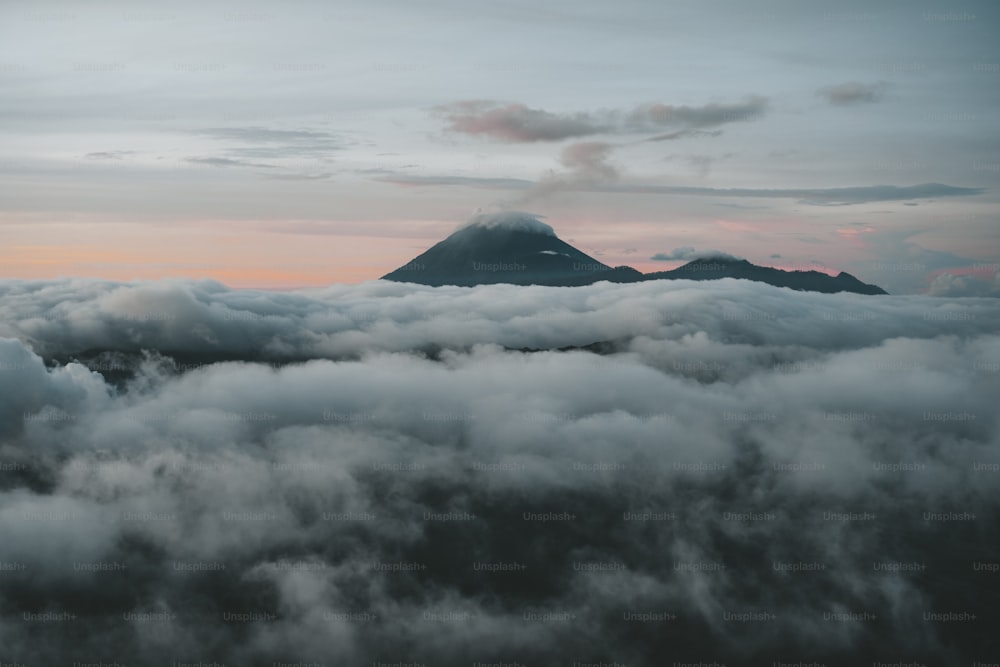 a view of a mountain in the clouds