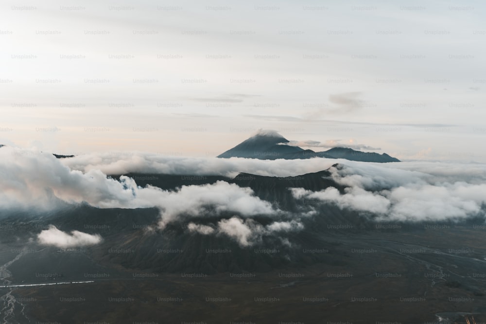 a view of a mountain range with clouds in the foreground