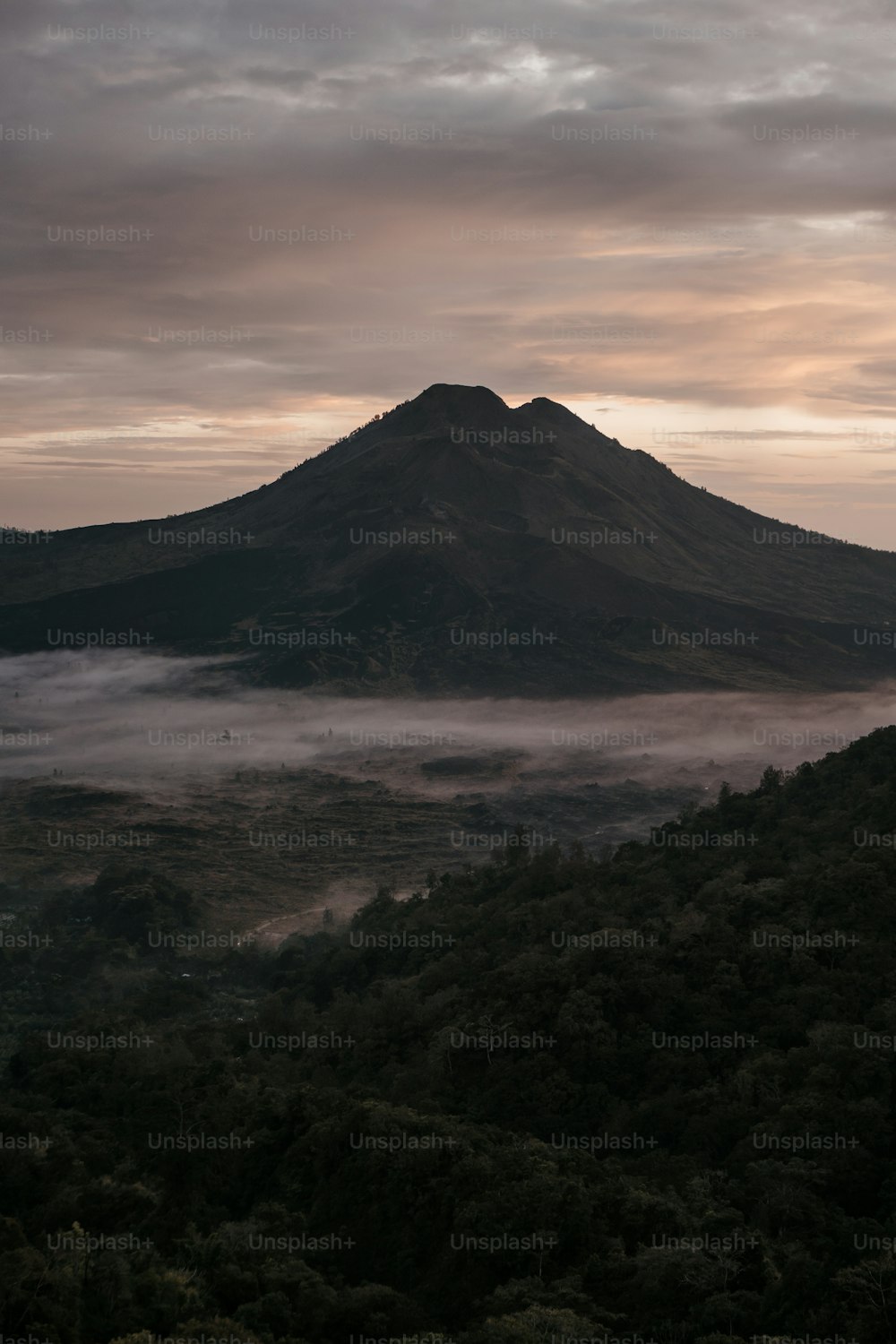 a mountain covered in fog in the distance