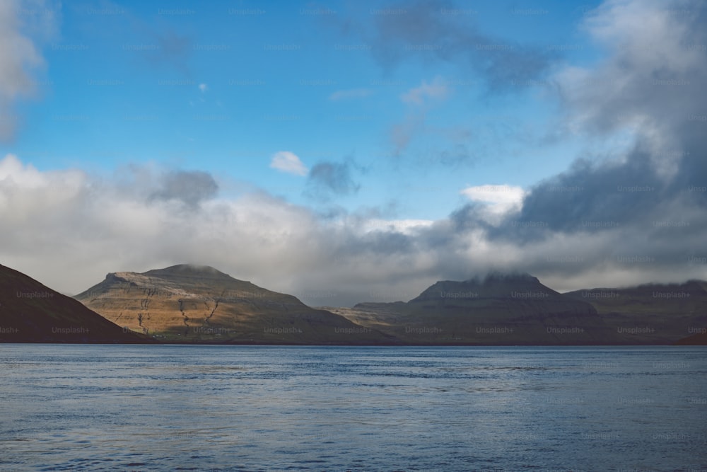 a large body of water with mountains in the background