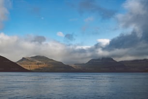 a large body of water with mountains in the background