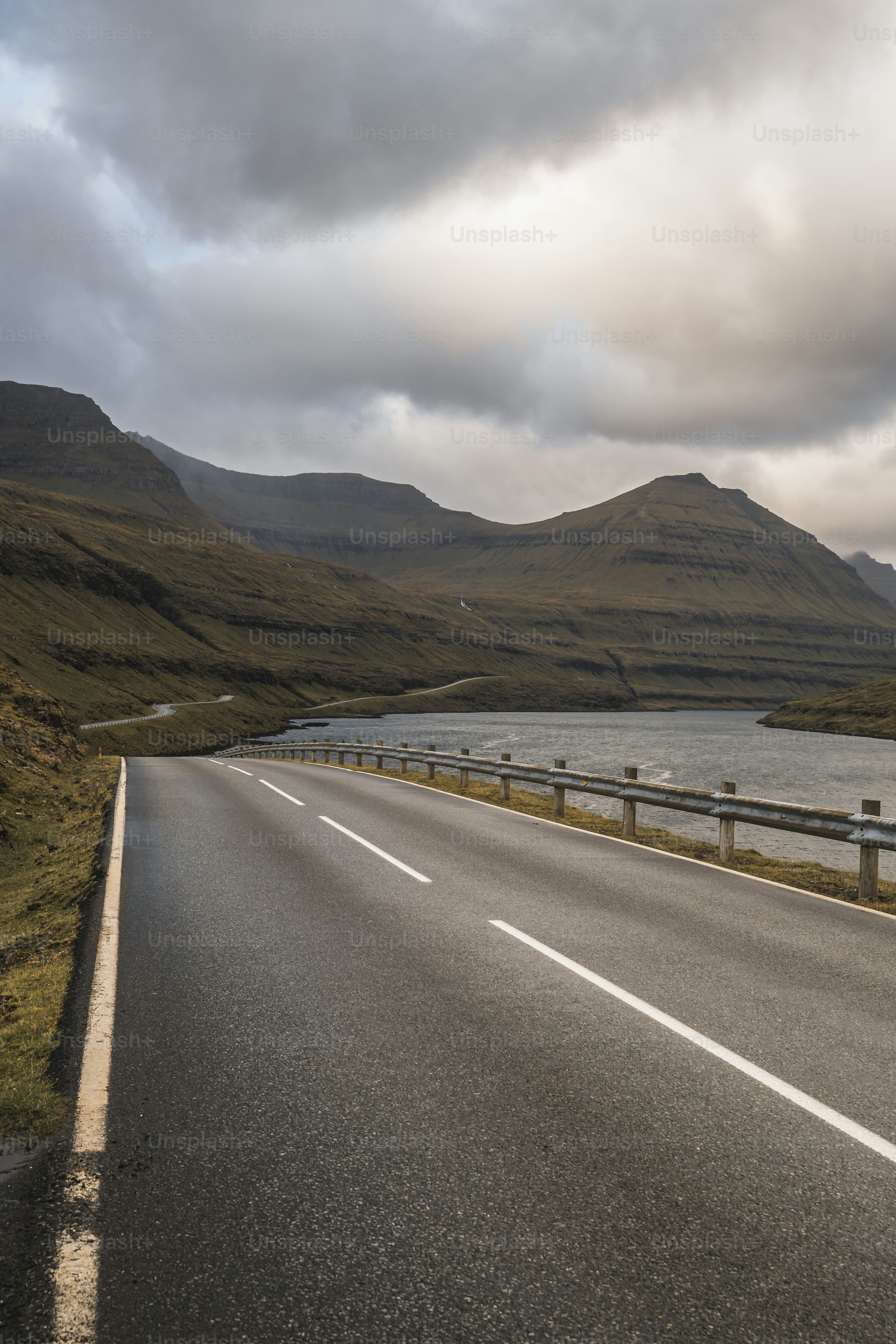 a long road with a body of water in the middle of it
