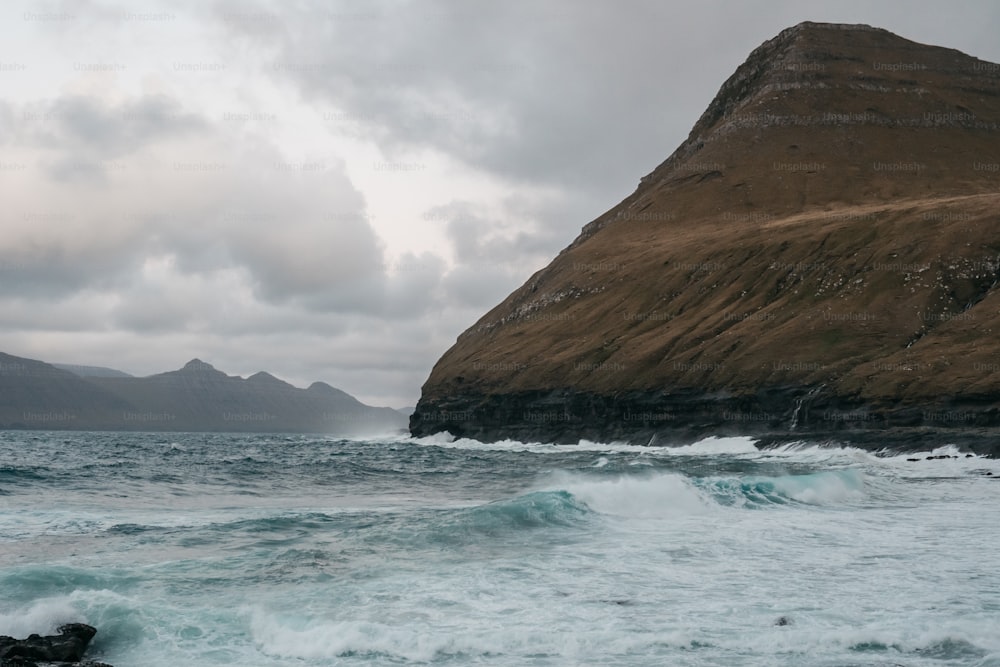 a large rock sitting on top of a body of water