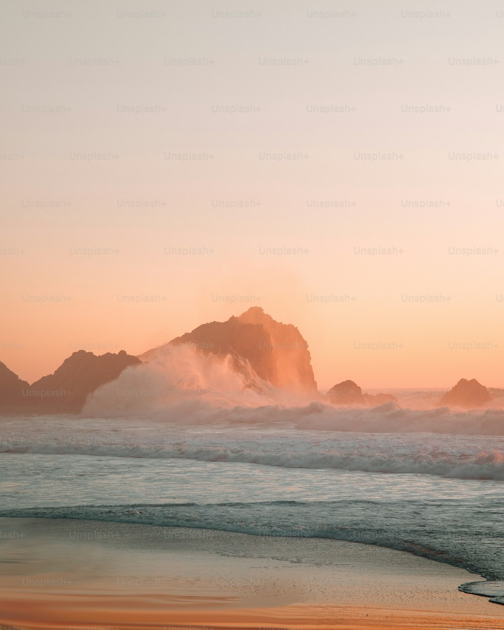 a large body of water sitting next to a sandy beach