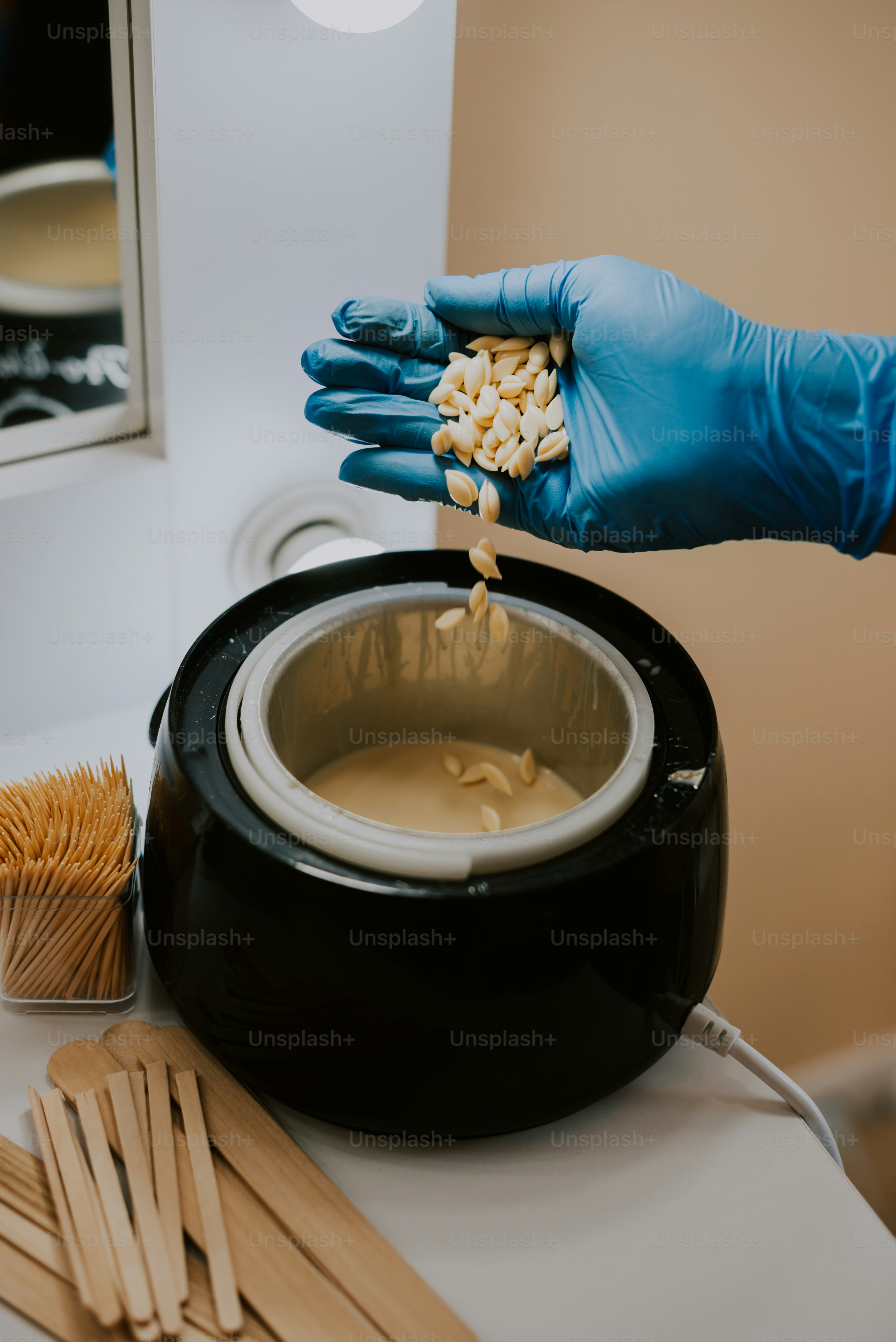 a person in a blue glove is putting something in a bowl