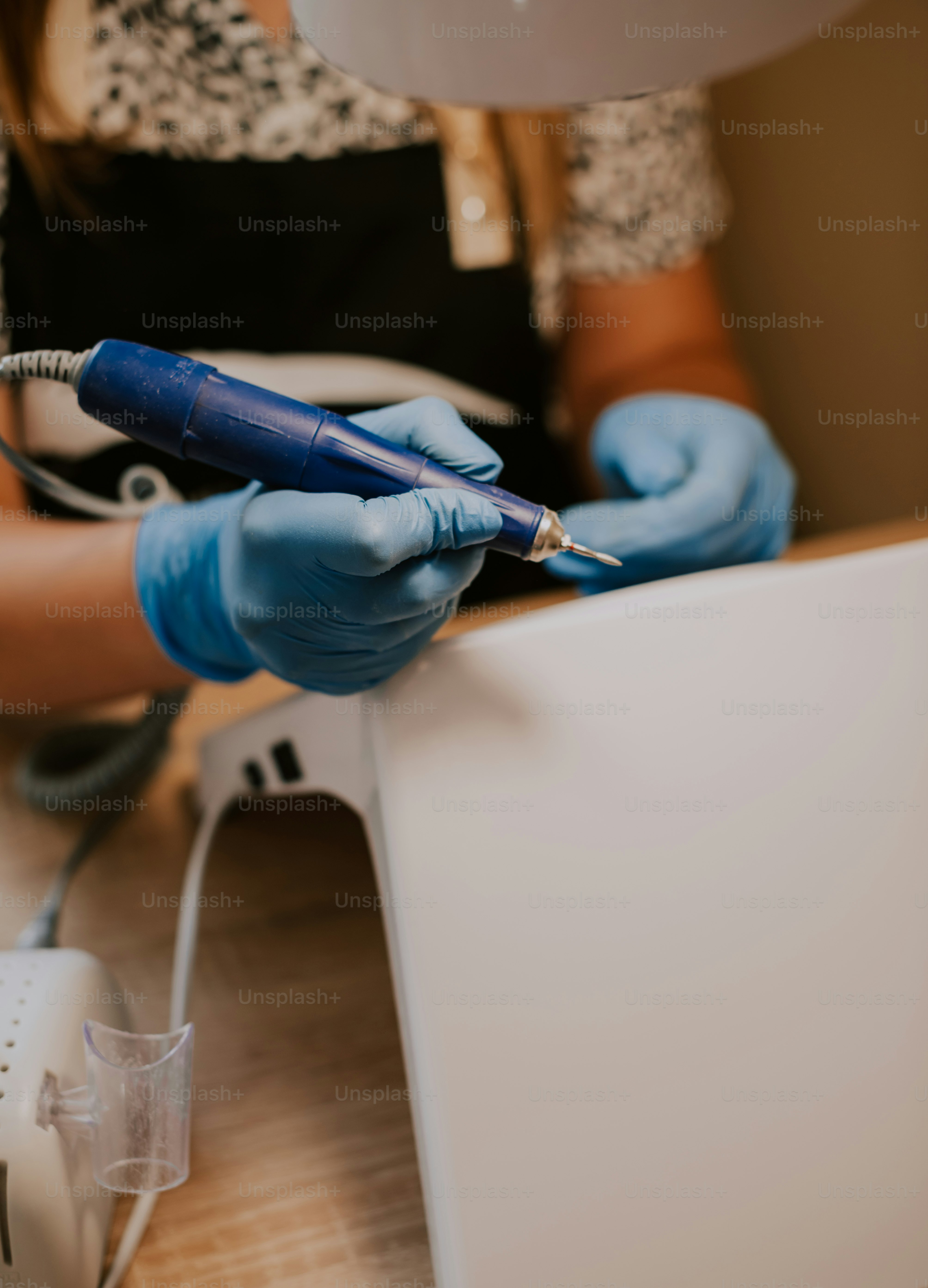 a person in blue gloves holding a pen