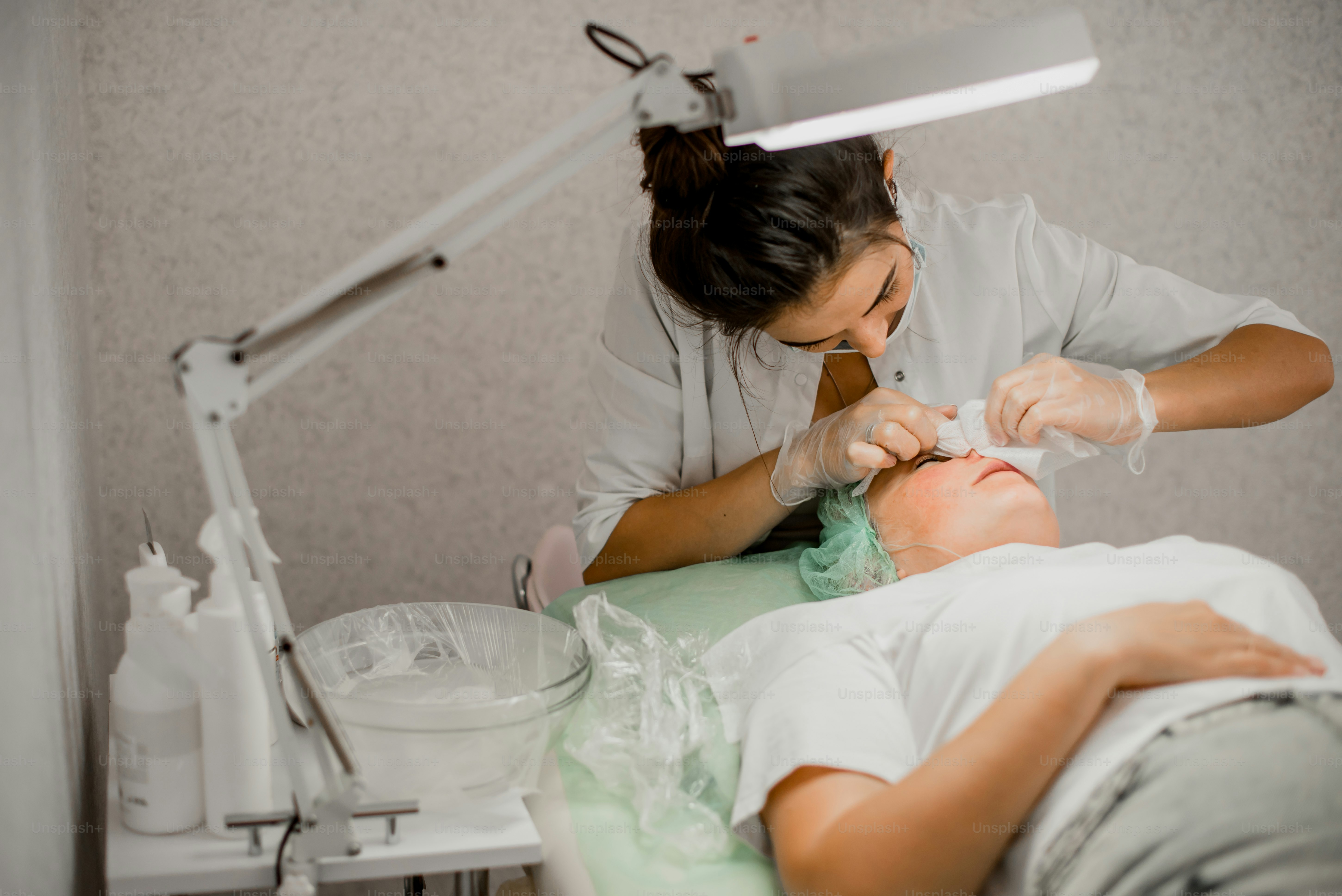 a woman getting her teeth checked by a dentist